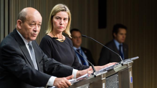 European Union High Representative for Foreign Affairs and Security Policy Federica Mogherini, right, and France's Defense Minister Jean-Yves Le Drian address the media during an EU foreign and defense ministers meeting at the EU Council building in Brussels on Tuesday, Nov. 17, 2015. France has demanded that its European partners provide support for its operations against the Islamic State group in Syria and Iraq and other security missions in the wake of the Paris attacks. (AP Photo/Geert Vanden Wijngaert)