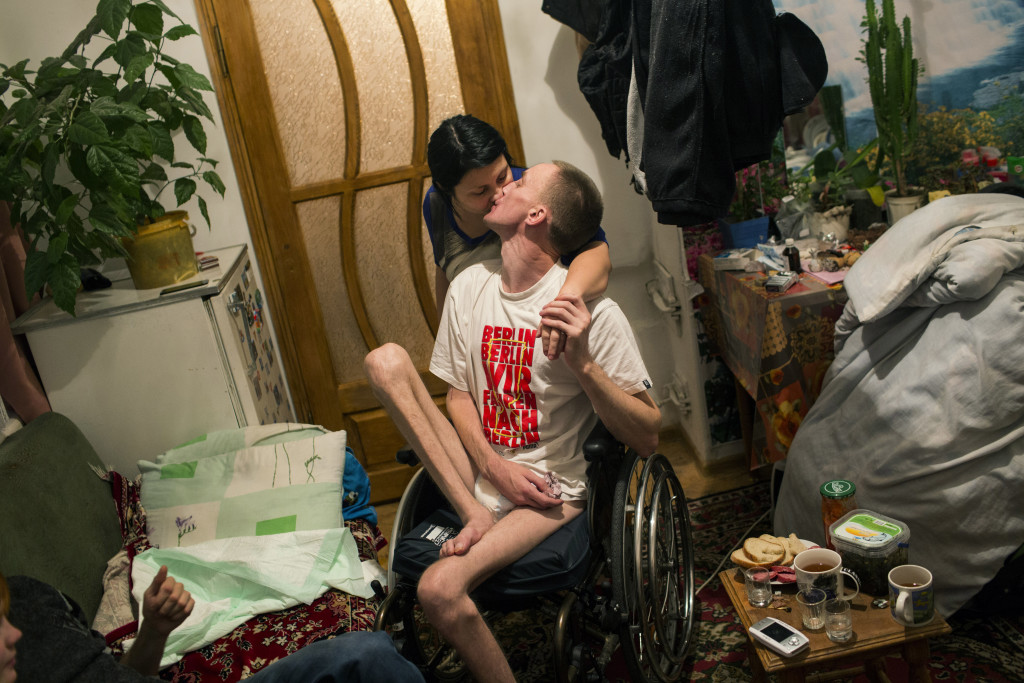Volodymyr Honcharovsky, 31, a married father of four children, kisses his wife, Oksana, in their home in Teofipol, Ukraine, Nov. 17, 2014. He was severely wounded on Feb. 20, 2014, when he was shot three timesÑtwice in the back, once in the right armÑwhile attempting to reach wounded demonstrators who had been shot by security forces during the Euromaidan revolution in Kiev. ÒLife for us is very difficult at the moment," said Oksana Khivchuk, his wife. We hoped that he would slowly begin to walk again, but as you see, there have been no changes."
