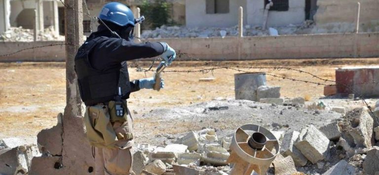 Un membro di una squadra investigativa sulle armi chimiche dell'ONU preleva campioni vicino a Damasco, in Siria, il 28 agosto 2013. Credits to: AP/United Media Office of Arbeen.